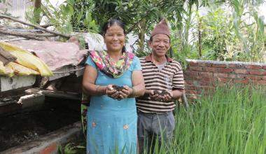 A Nepalese couple holding soil